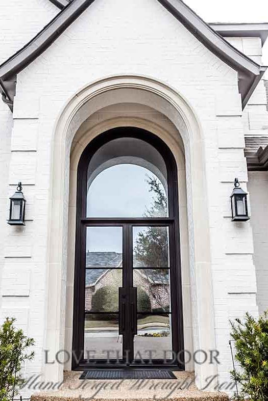 Exquisite iron door and transom combination showcasing elegant geometric patterns.