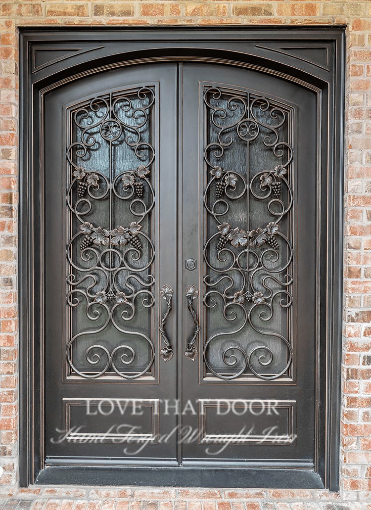 Handcrafted iron double doors with personalized monogram or emblem