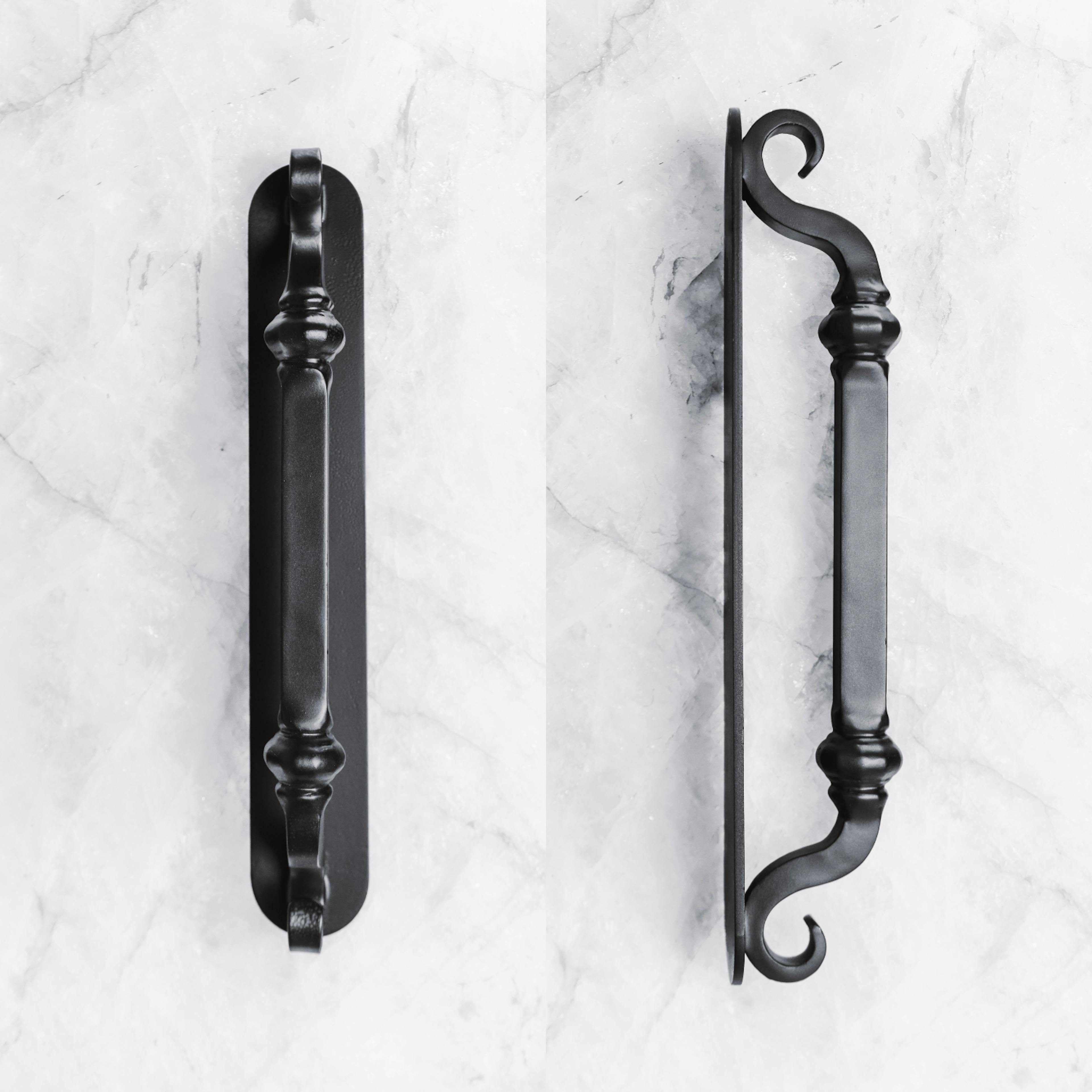 Handcrafted iron door pull with hammered texture and artisanal appeal