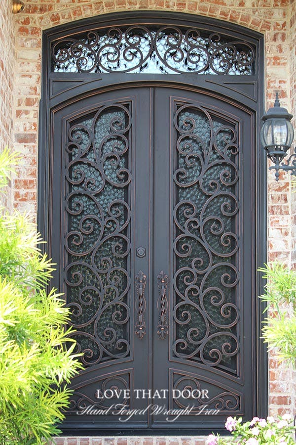 Artistically designed iron door and transom arrangement, blending strength and beauty seamlessly.