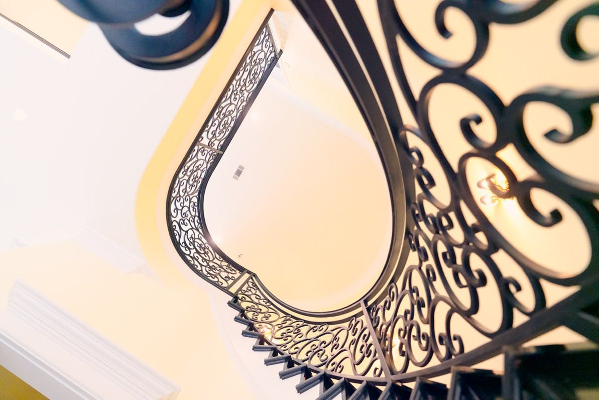 Artfully crafted iron railing, showcasing intricate detailing and craftsmanship.