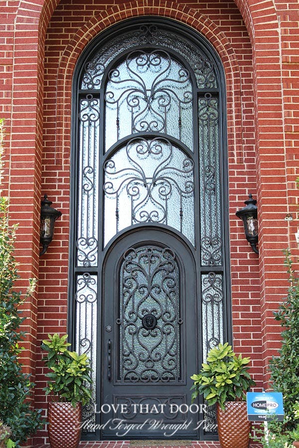 Elegant iron double doors with transom, creating a striking focal point for your home.