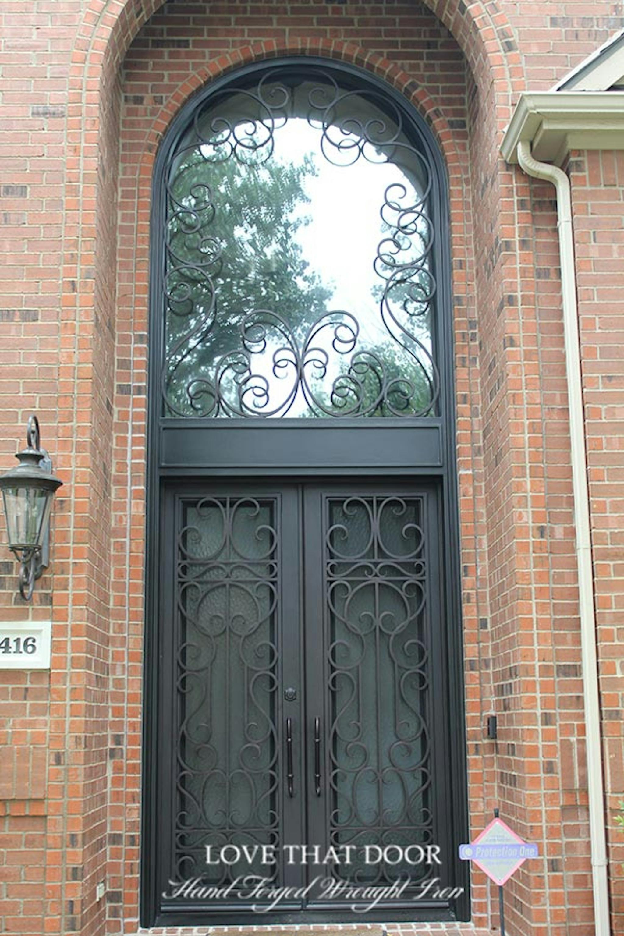 Beautifully crafted iron door and transom ensemble, adding a touch of grandeur to any entrance.