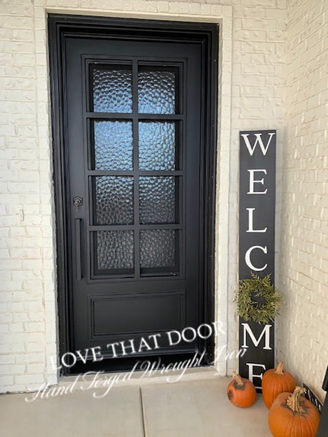 Single iron door with hand-painted design and colorful accents