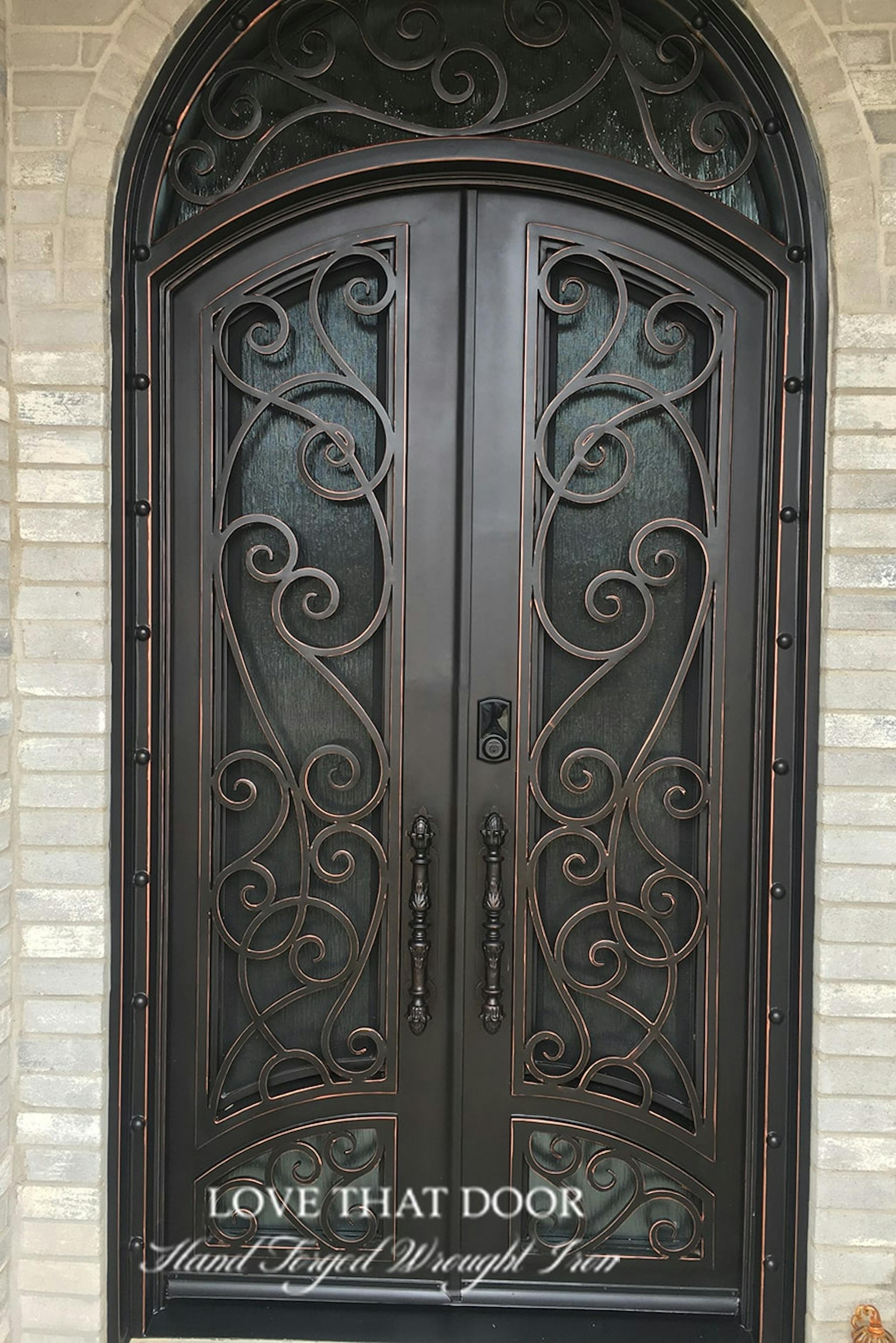 Timeless beauty: iron door with transom window, adding character to your home's façade.