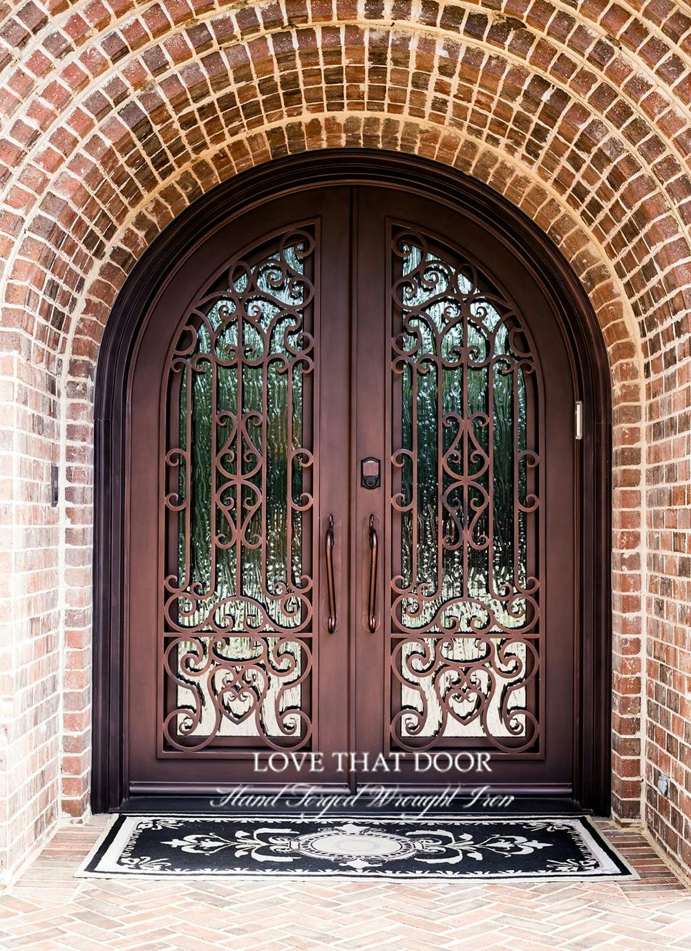 Stylish iron double doors with intricate metalwork and glass panels