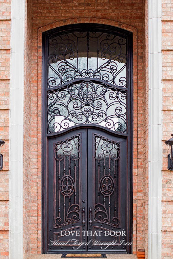 Traditional door transom with decorative mullions and a graceful curve.