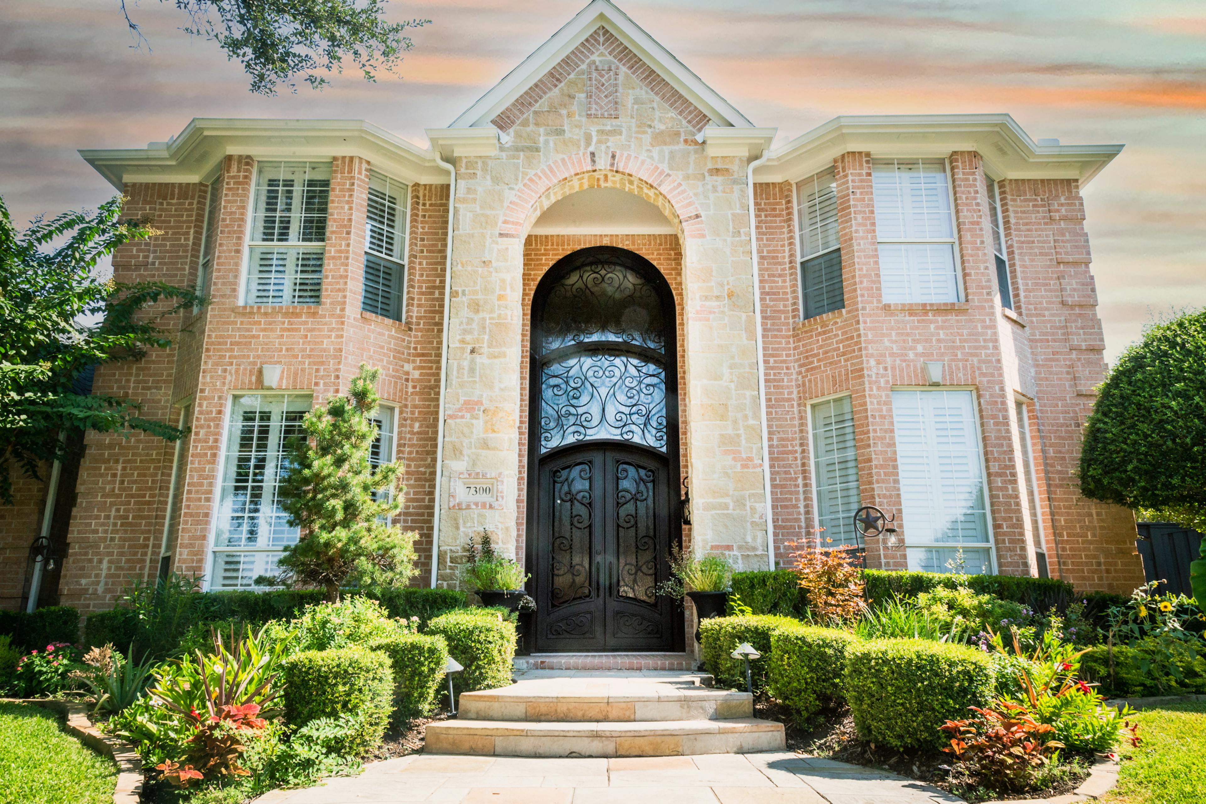 Traditional door transom with decorative mullions and a graceful curve.