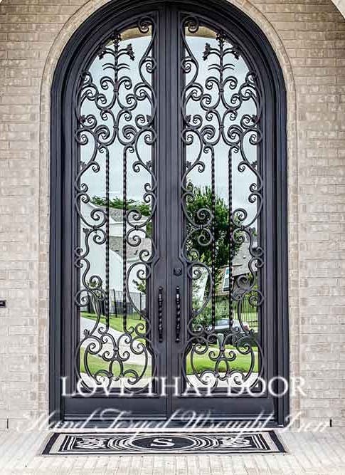Iron double doors with decorative grillwork and patterns for added charm