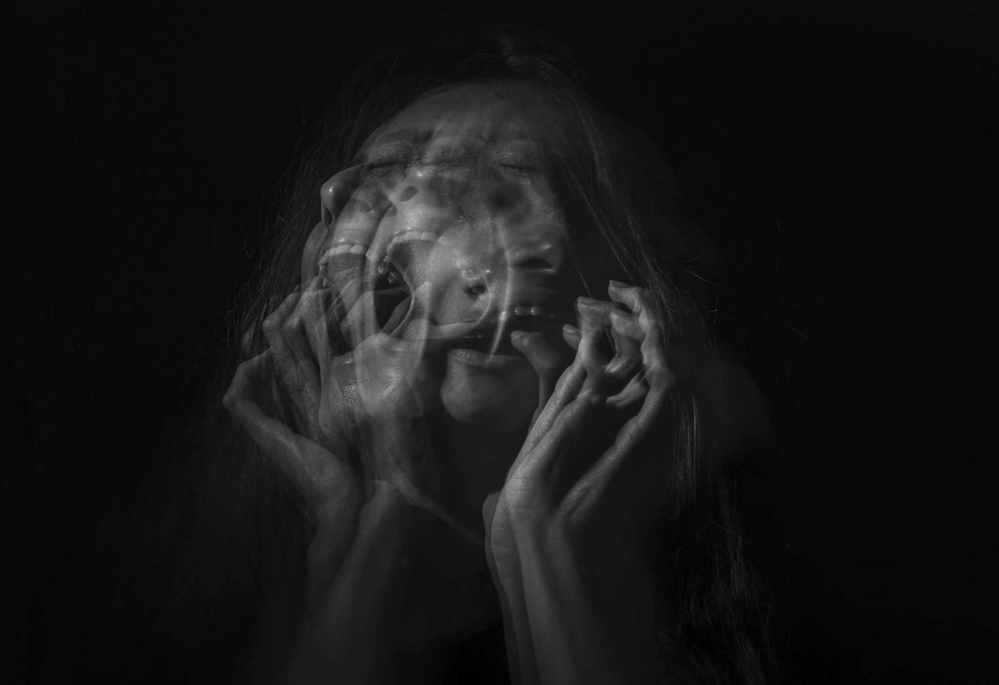 Abstract women in black and white screaming in obvious distress