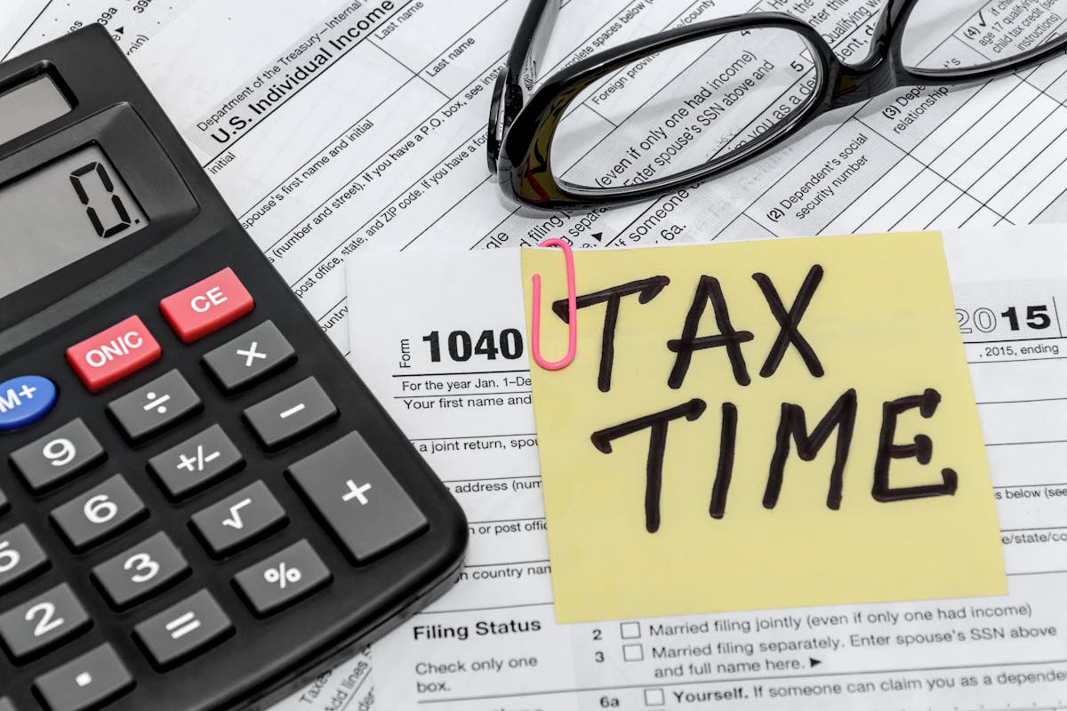 tax form with calculator and glasses

