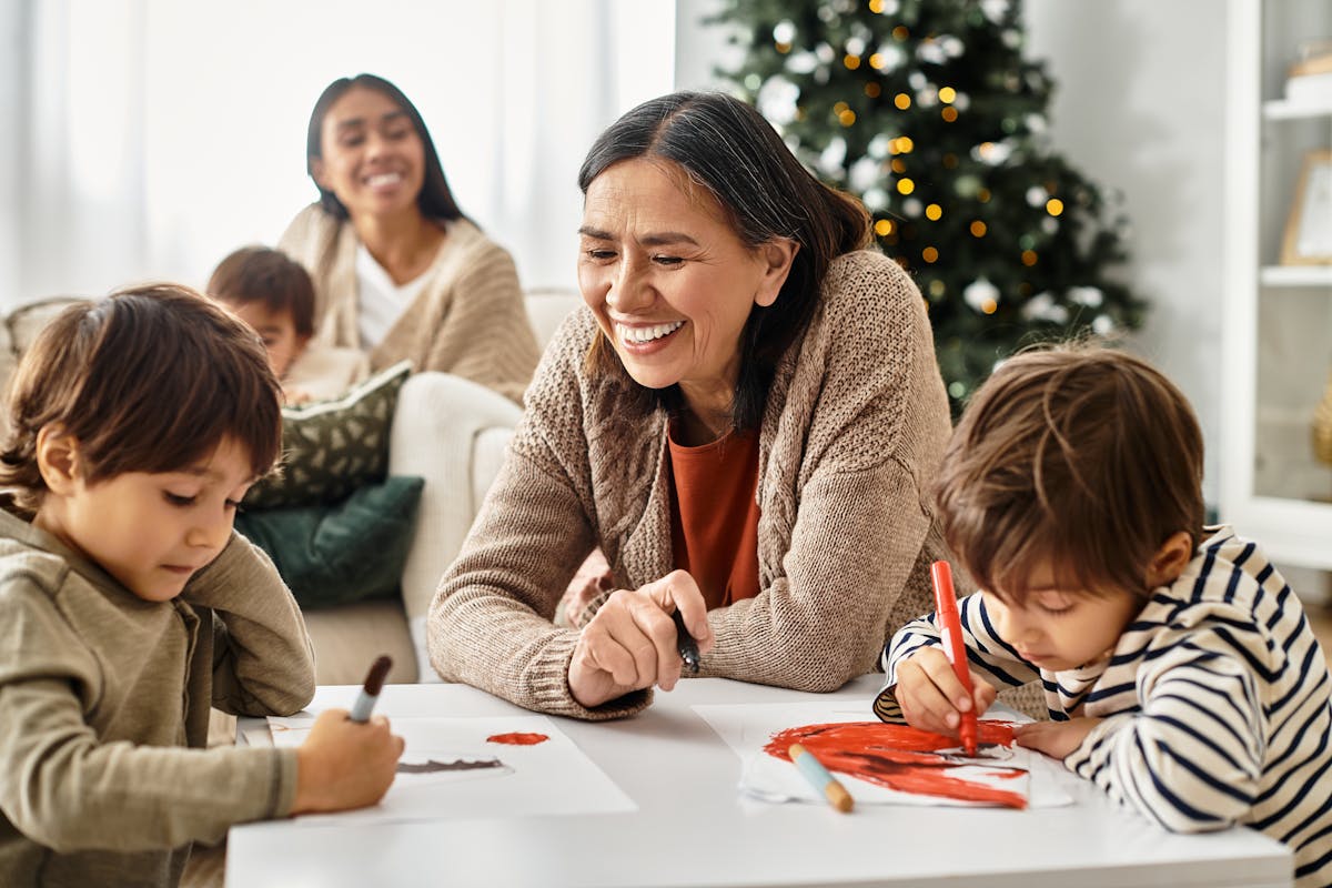 A happy family celebrates Christmas together, sharing laughter and crafting colorful artworks in a cozy living room.