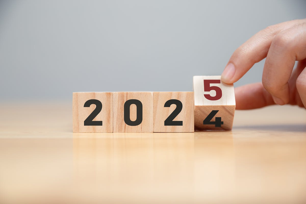 New project growth concept in 2025, Preparation for happy new year , Hand of man flip wooden cube from 2024 to 2025.