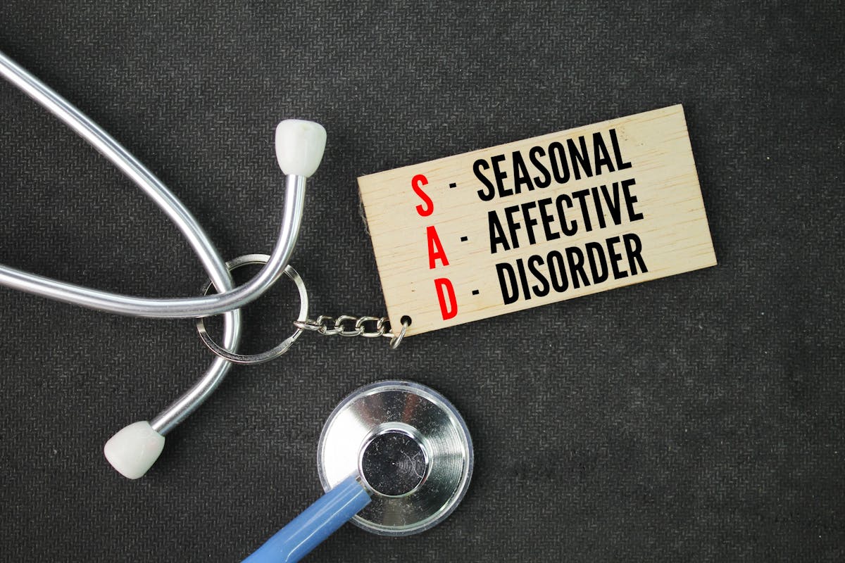 stethoscope and wooden tag with the word seasonal affective disorder. Light therapy and vitamin D are treatments for winter-pattern SAD