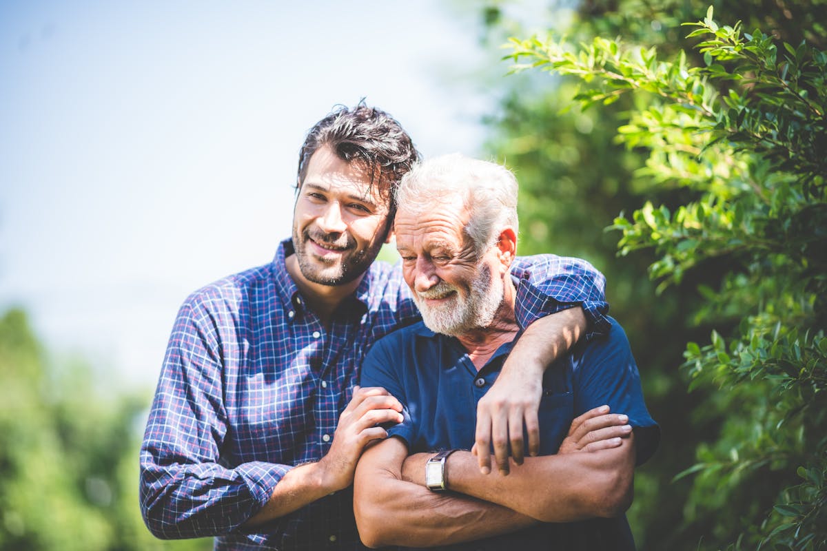 Adult hipster son and old senior father stay for work at home, two generations have a beard talking together and relaxing with smile, happy enjoy living to isolation quarantine at home, father's day