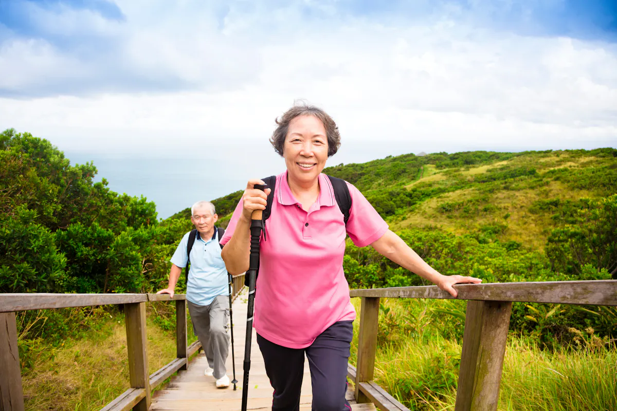 happy senior couple hiking on the mountain