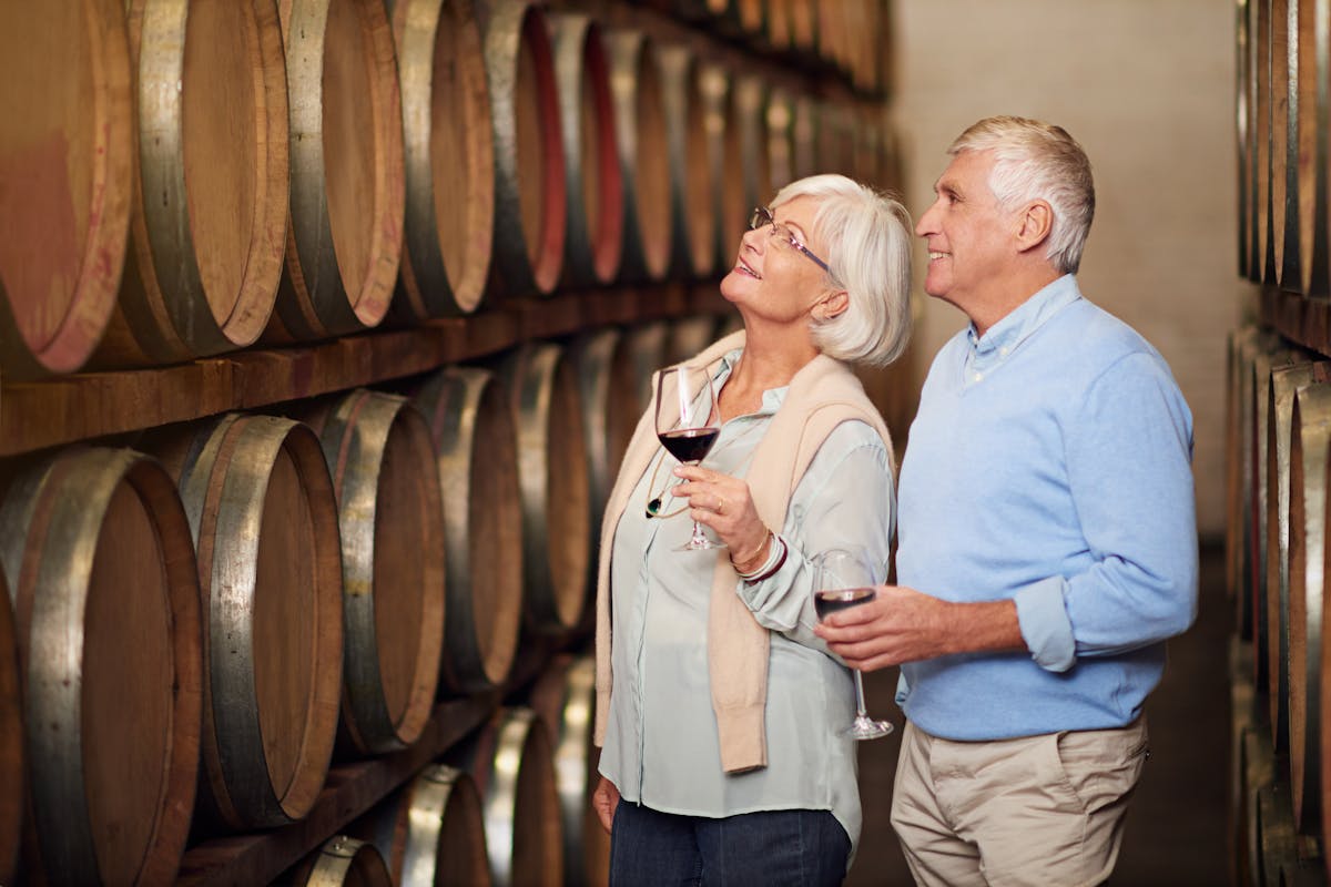 Theyve got a cellar full of wine. Cropped shot of an affectionate senior couple wine tasting in a cellar.