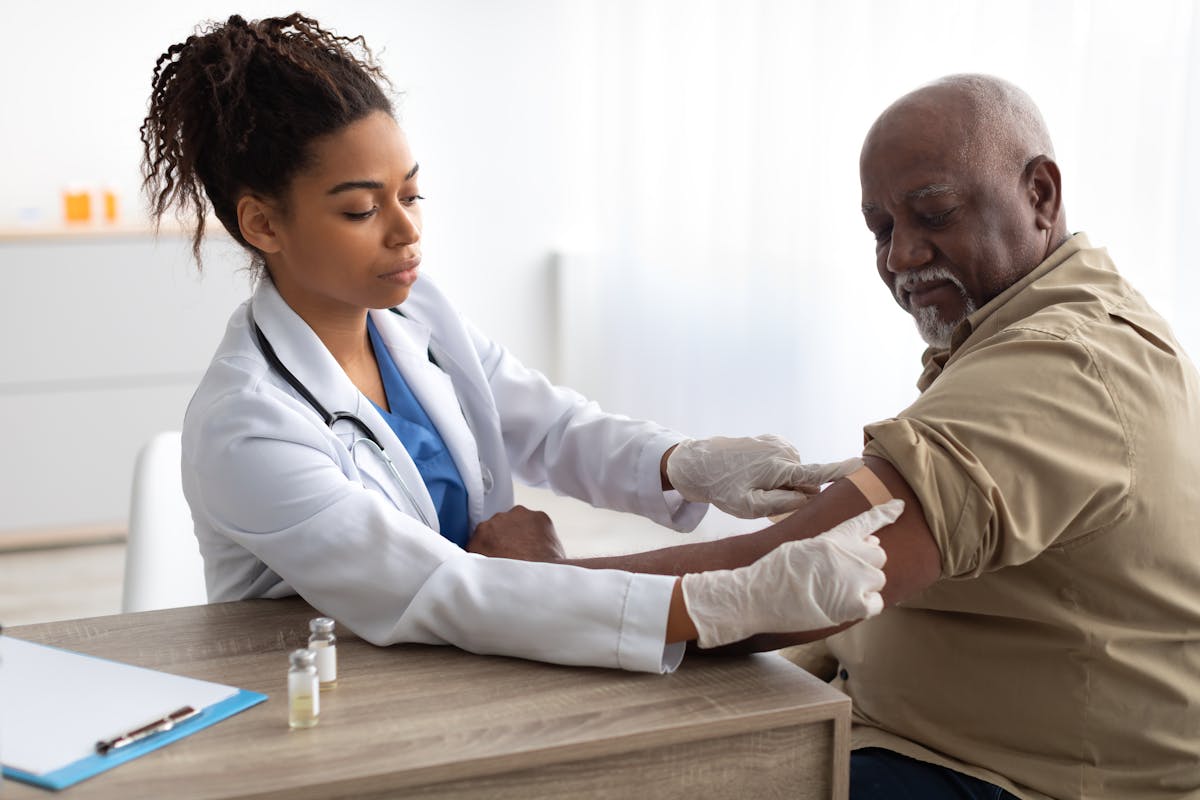 Senior Man Getting Vaccinated Against Covid, Doctor Applying Plaster