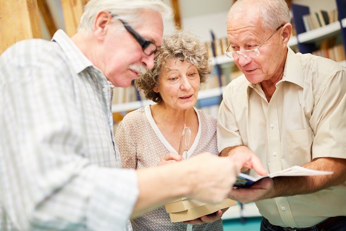 Group of seniors reading books full of curiosity