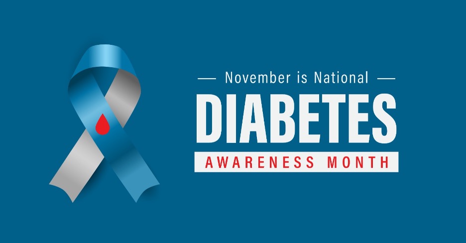 blue and gray diabetes awareness ribbon with a red droplet beside bold text reading “November is National Diabetes Awareness Month” on a blue background