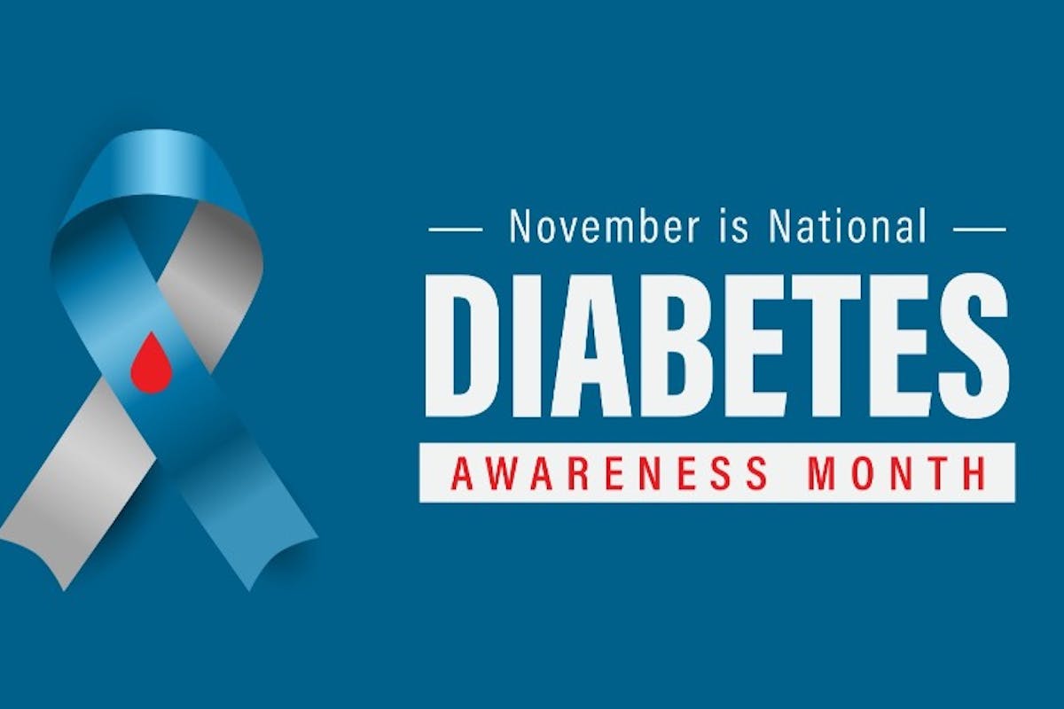 blue and gray diabetes awareness ribbon with a red droplet beside bold text reading “November is National Diabetes Awareness Month” on a blue background