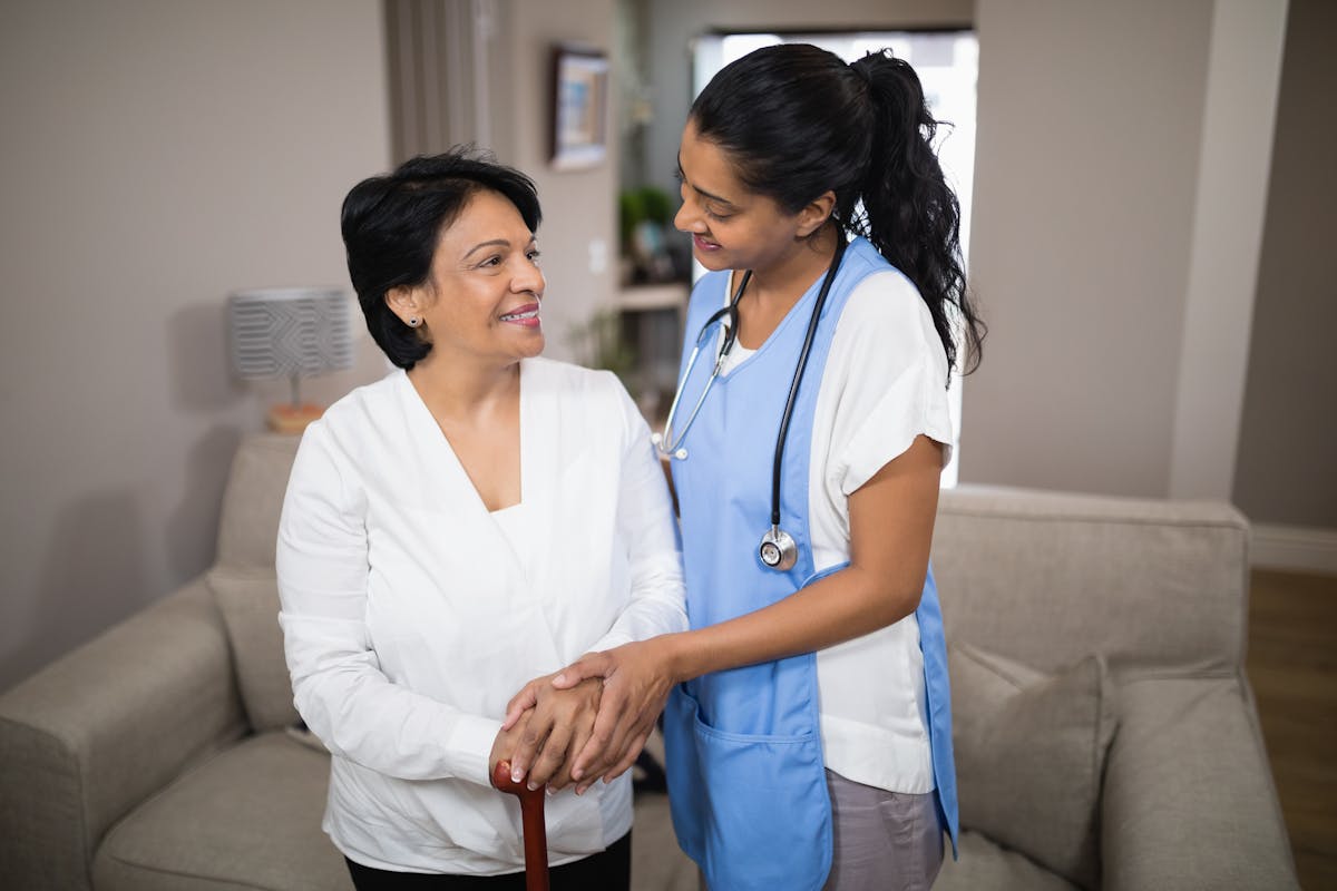 Young nurse standing with patient