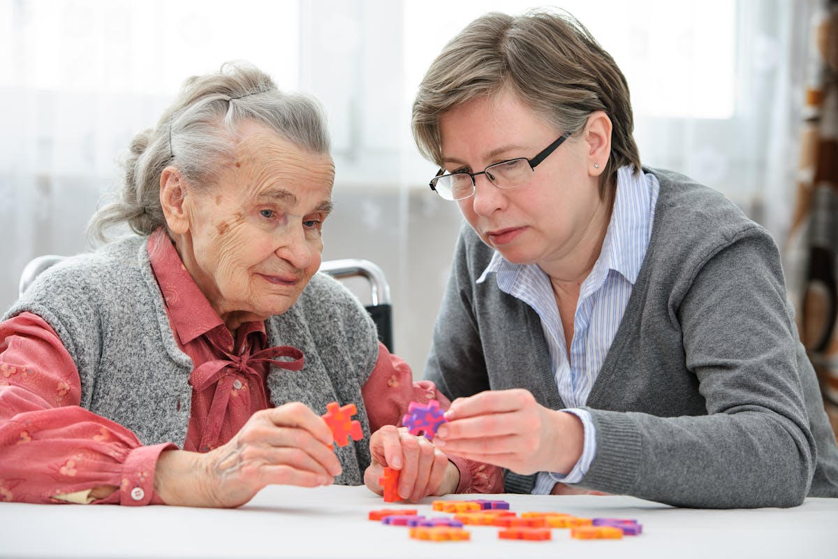 Senior woman with her elder care nurse
