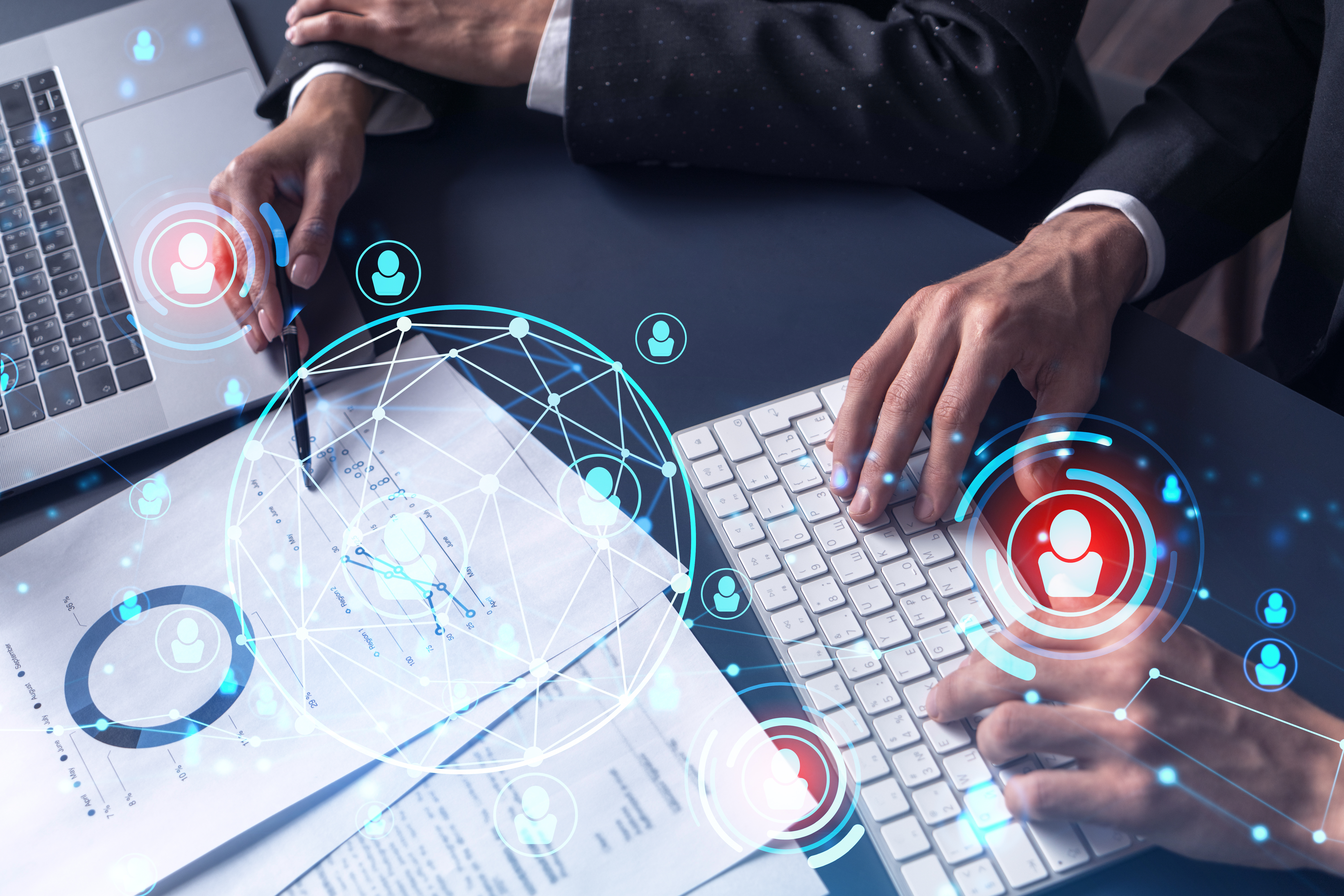 two people looking at their documents and pc