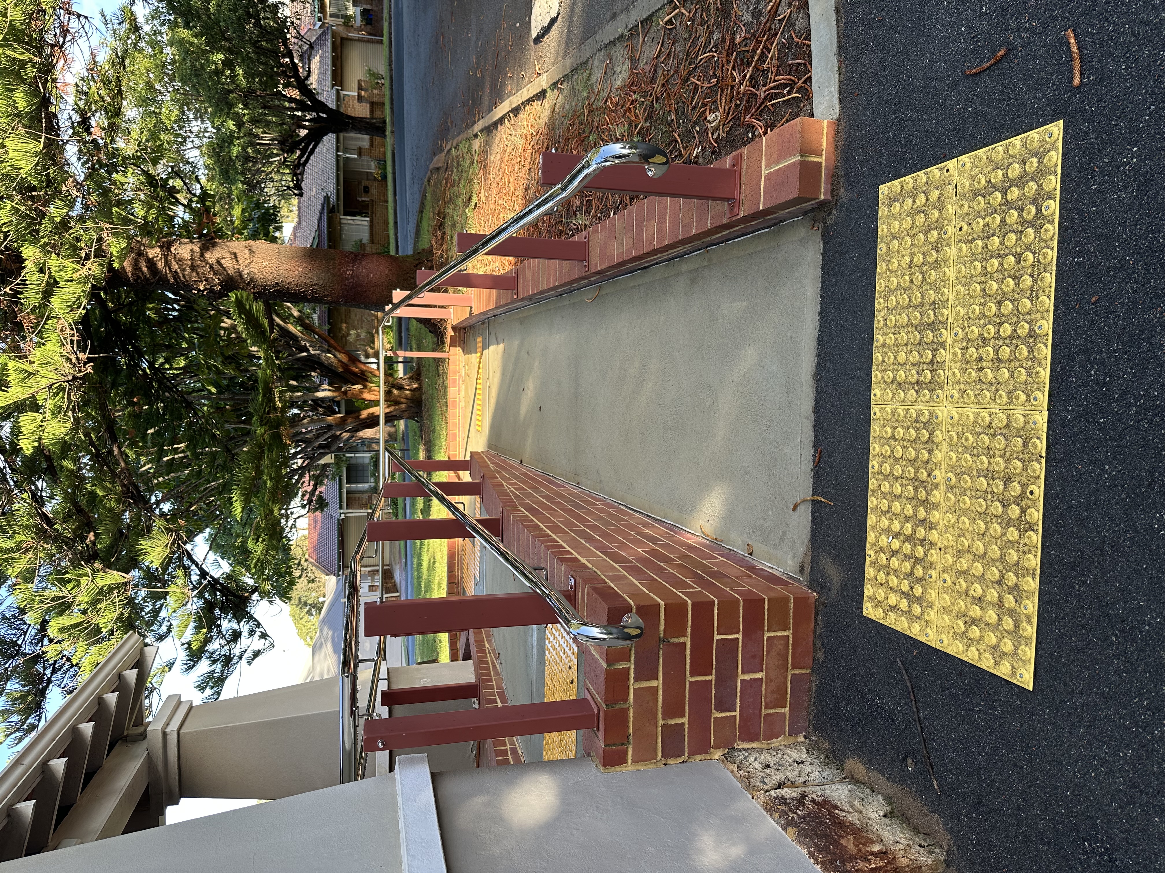 Accessible ramp with a yellow warning TGSI at the landing 