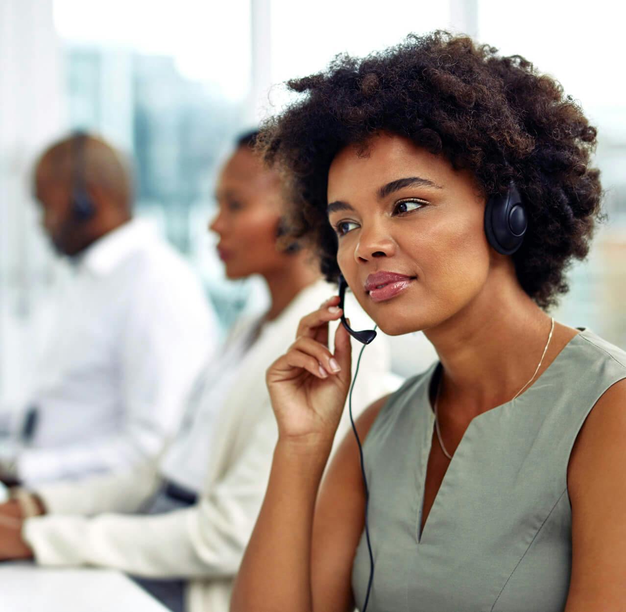 Underwriters talking to clients on headsets