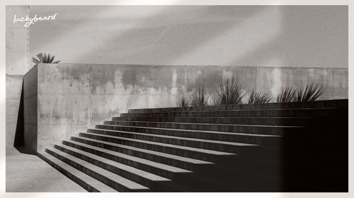 A concrete wall with some stairs in an urban setting