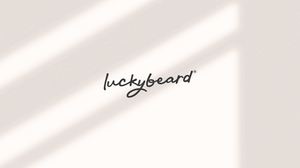 The luckybeard logo floating in the shadow of a window