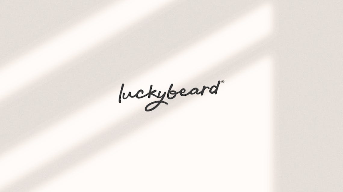 The luckybeard logo floating in the shadow of a window