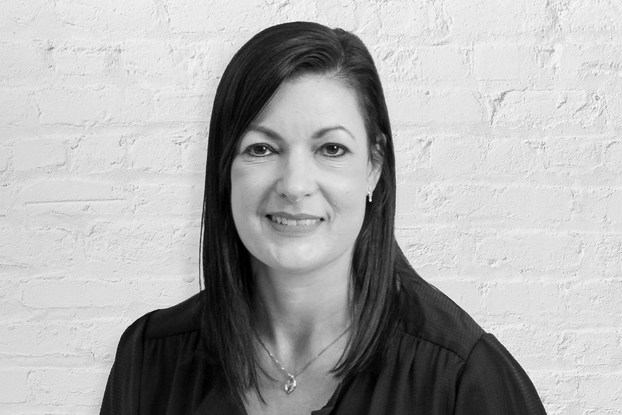 Person in front of brick wall