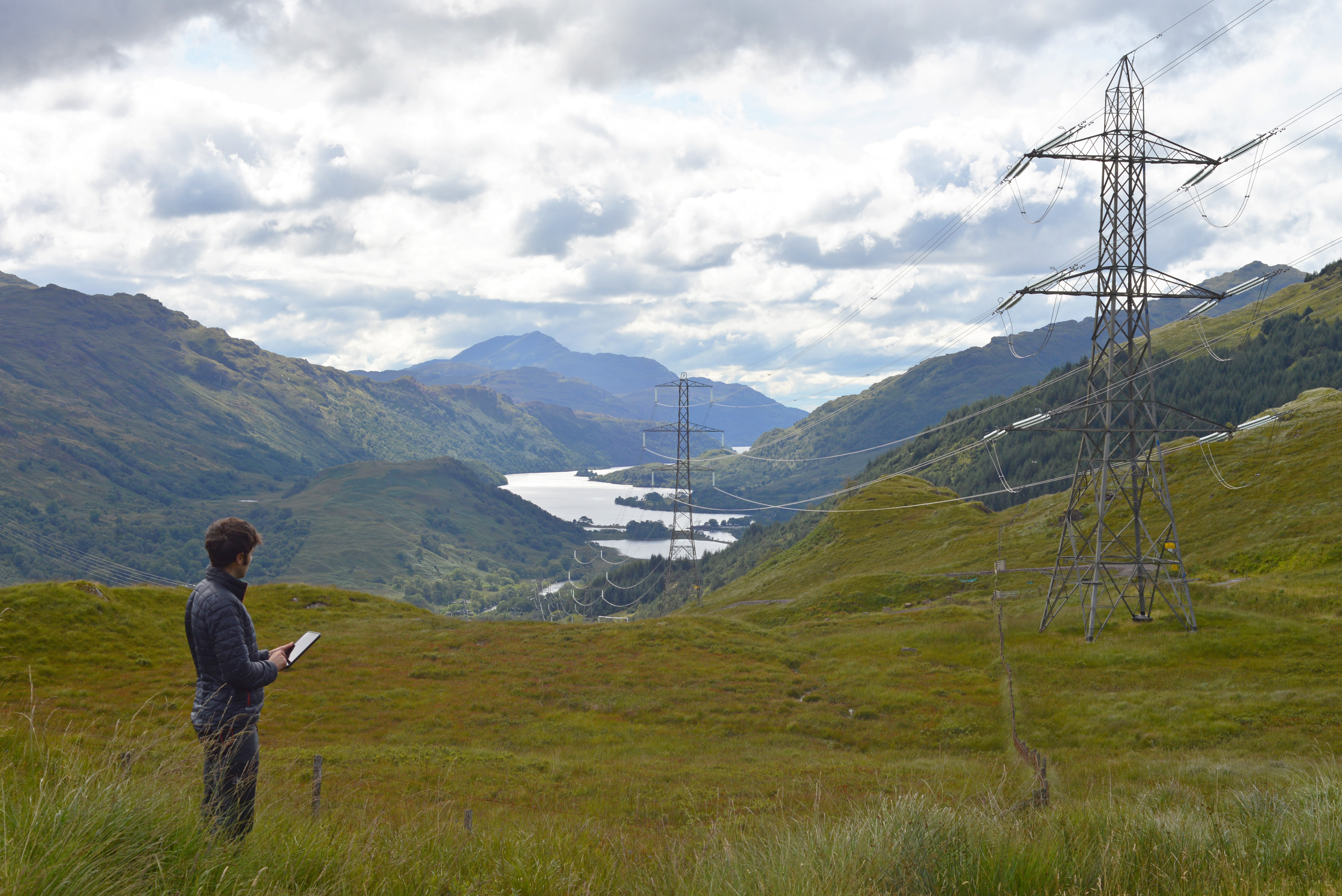 Person looking at pylons in mountain area