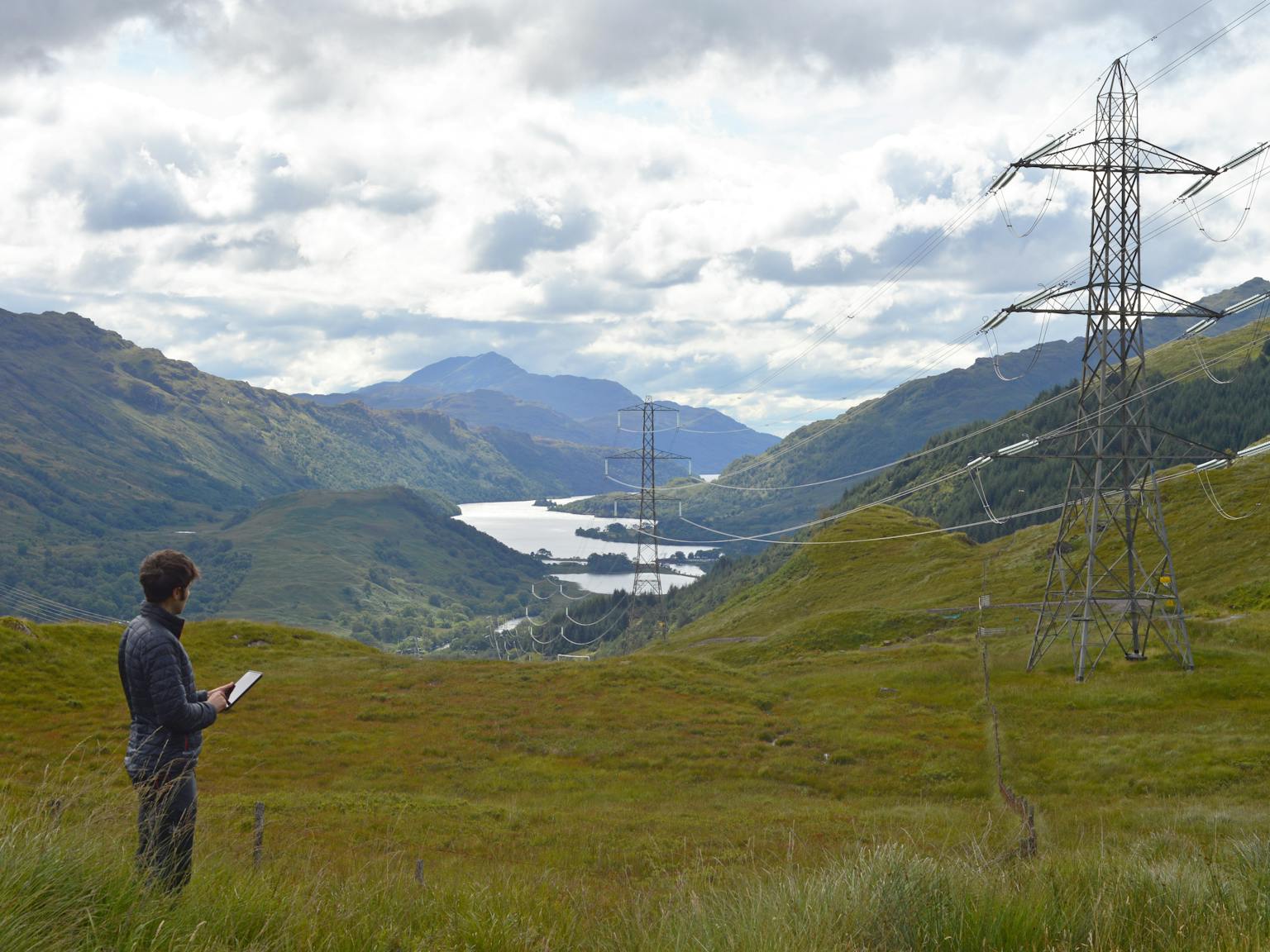 Person looking at pylons in mountain area