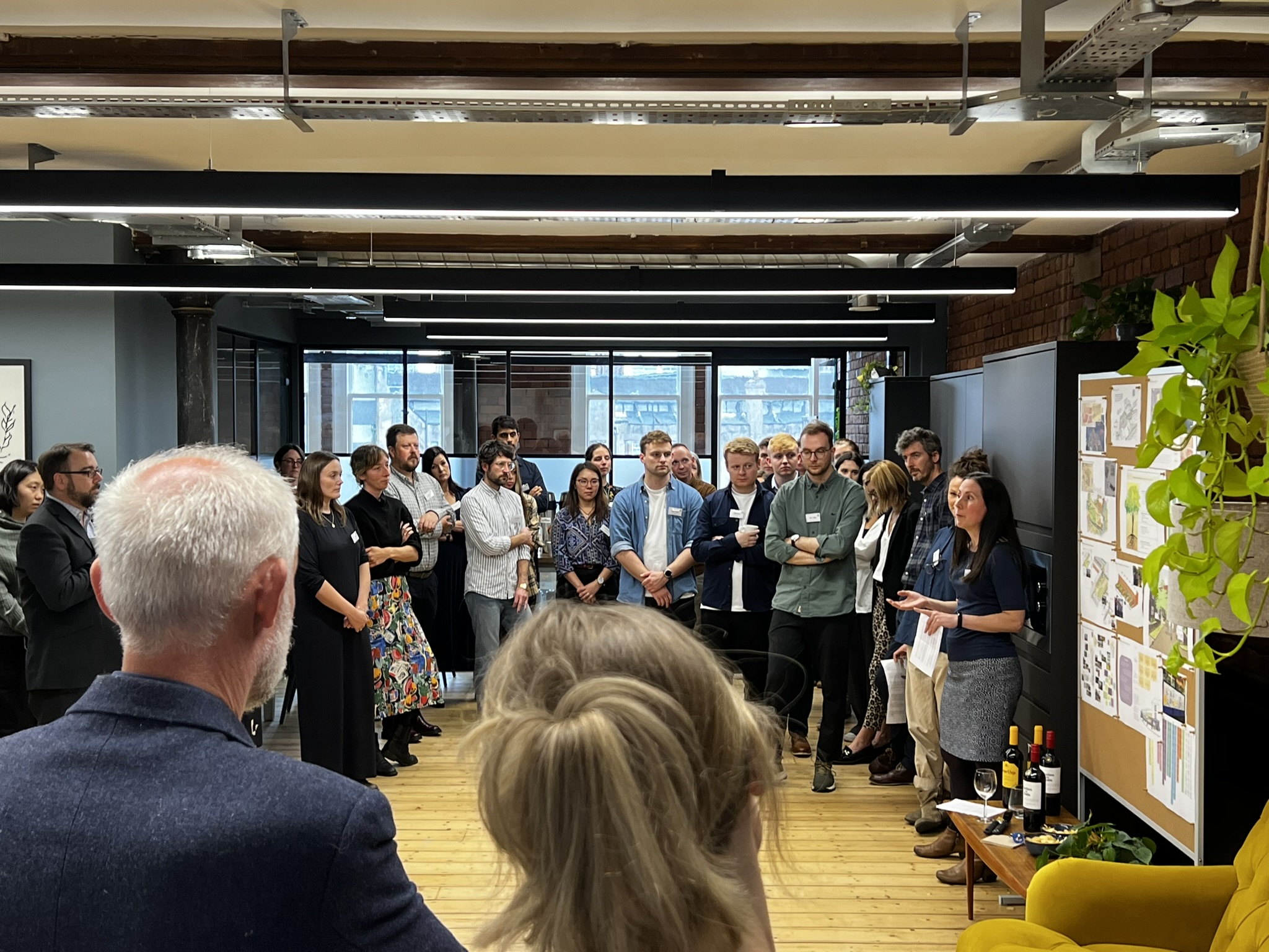 A group of people in a room watching a person talking