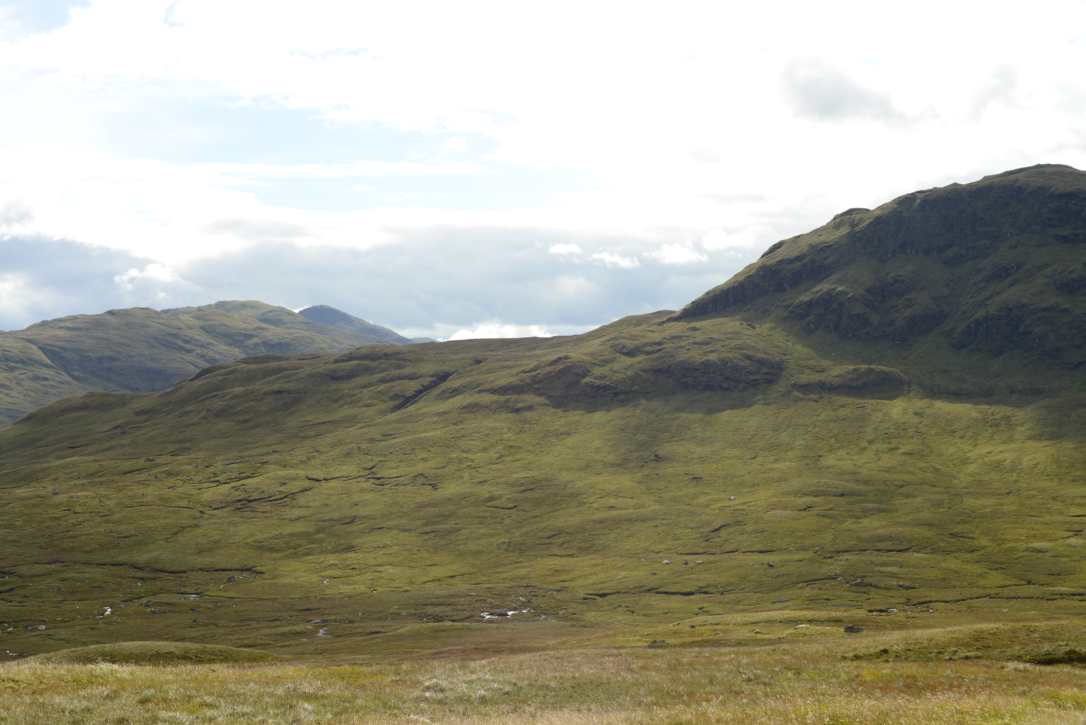 Green mountain with clouds