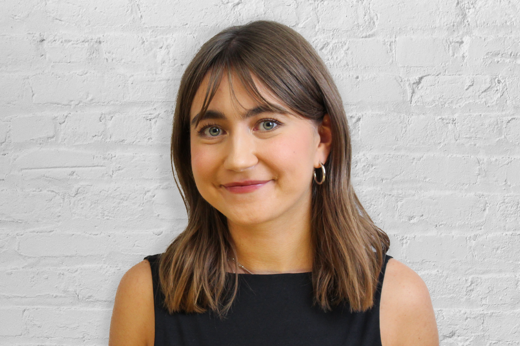 Person in front of brick wall