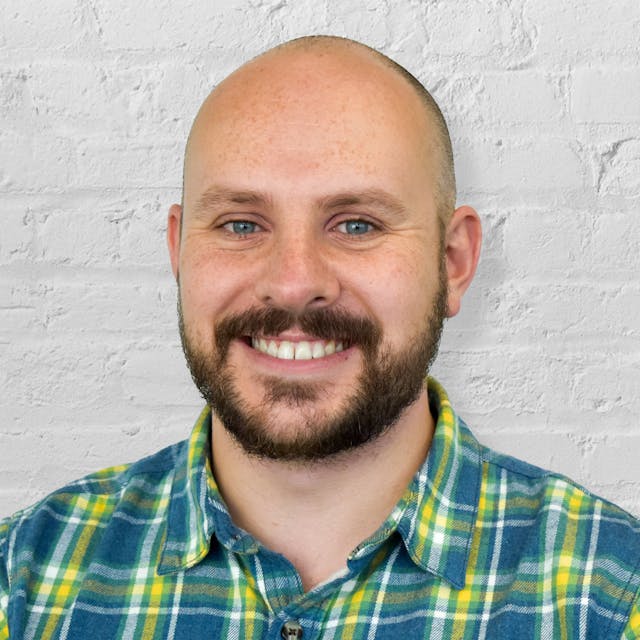 Person in front of brick wall