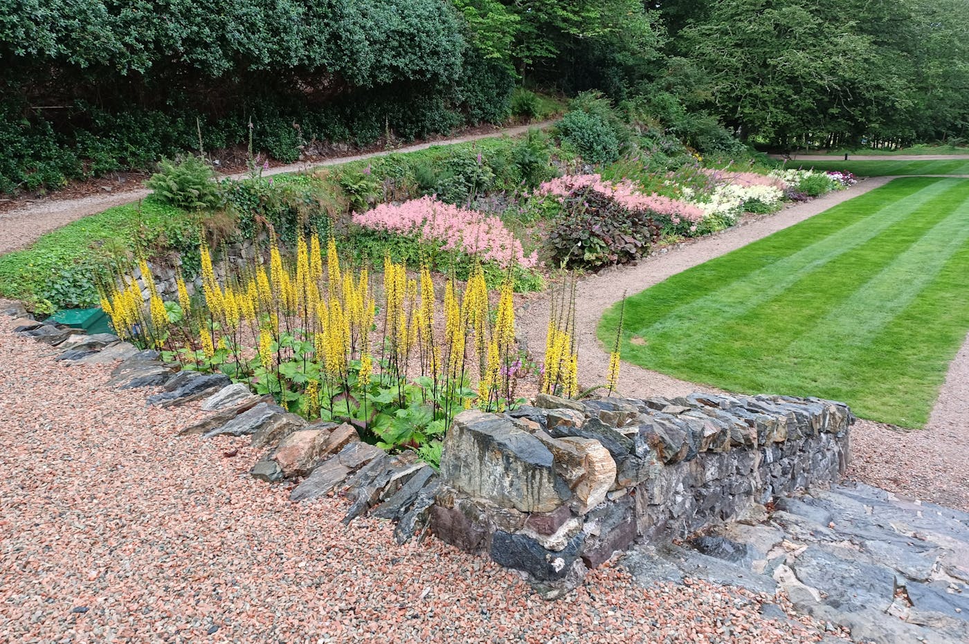 Stone pathway with planting beds and lawn