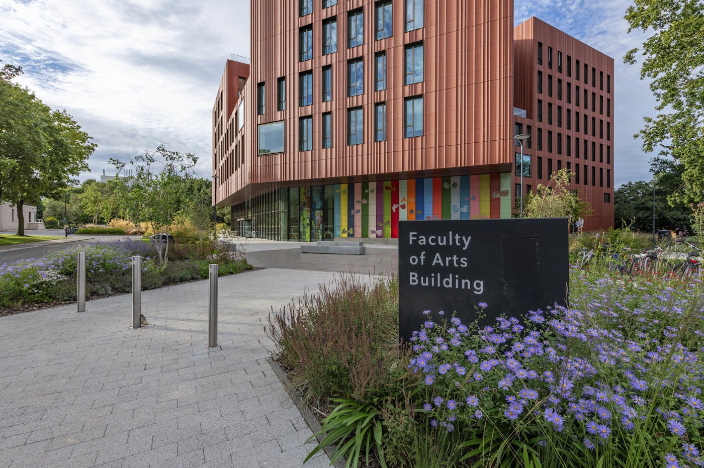 University building in paved area, sign saying Faculty of Arts Building