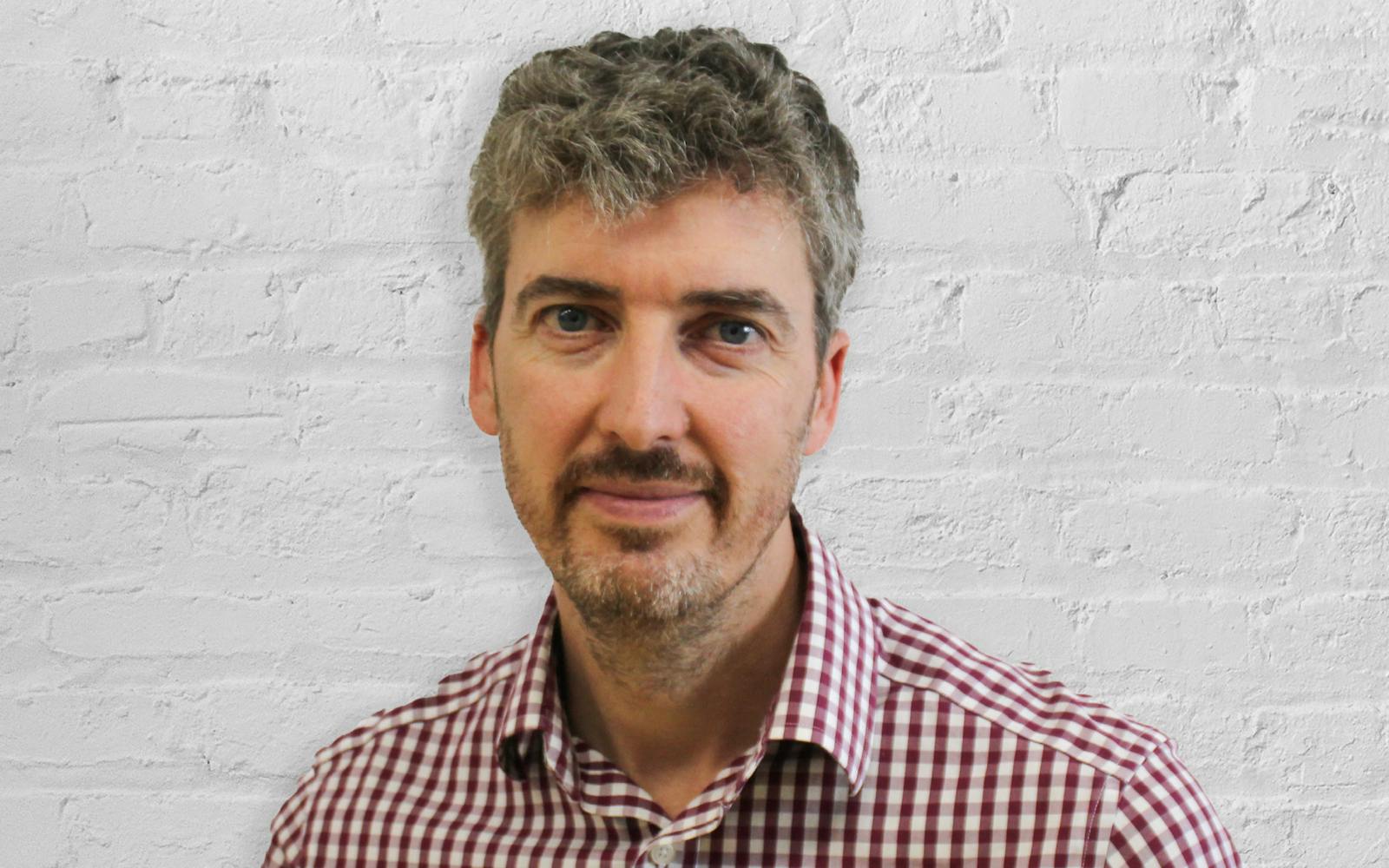 Person in front of white brick wall