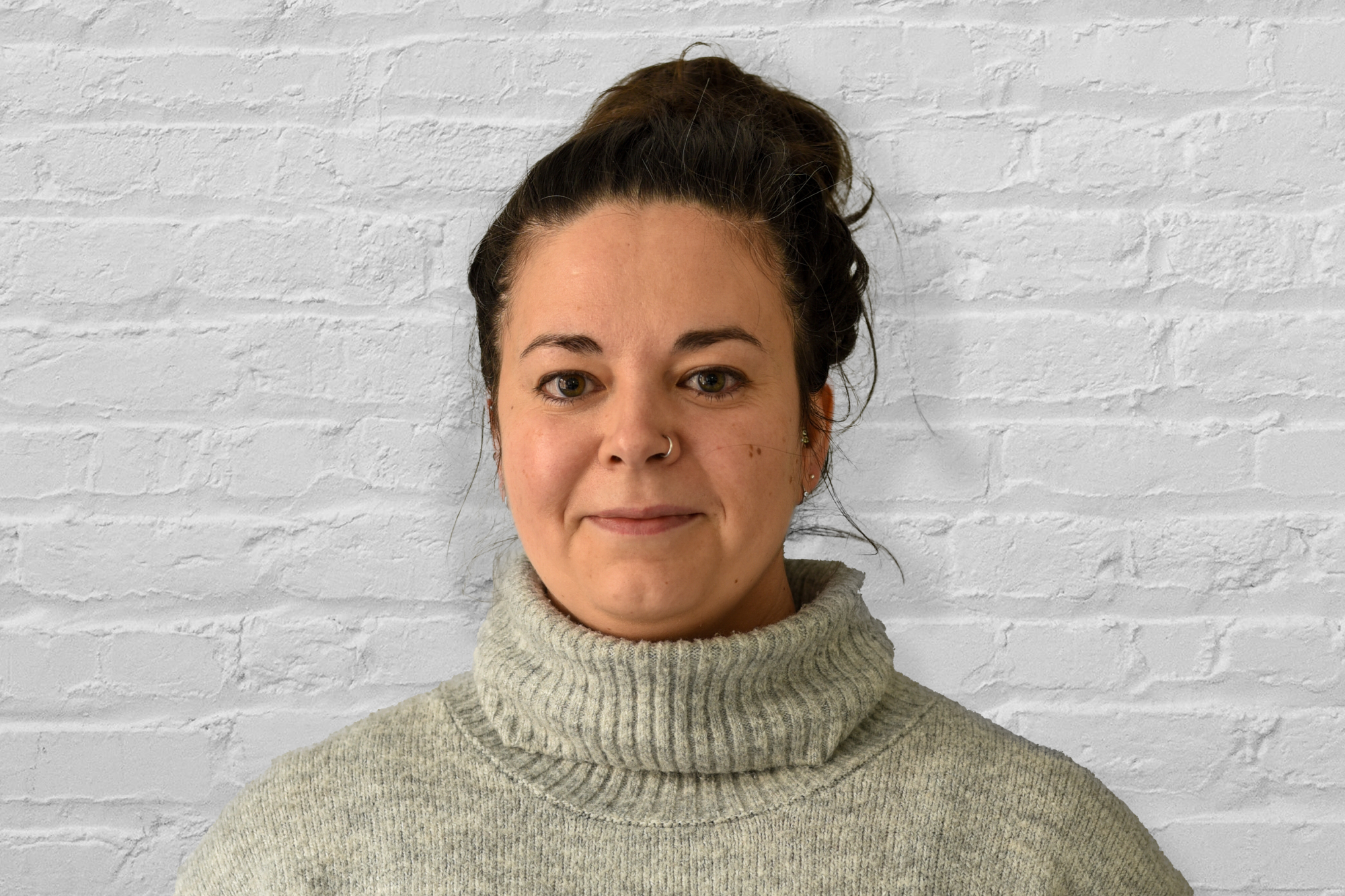 Person standing in front of brick wall
