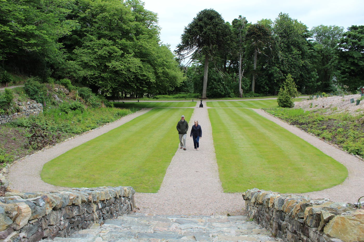 Sunken lawn garden with two people walking