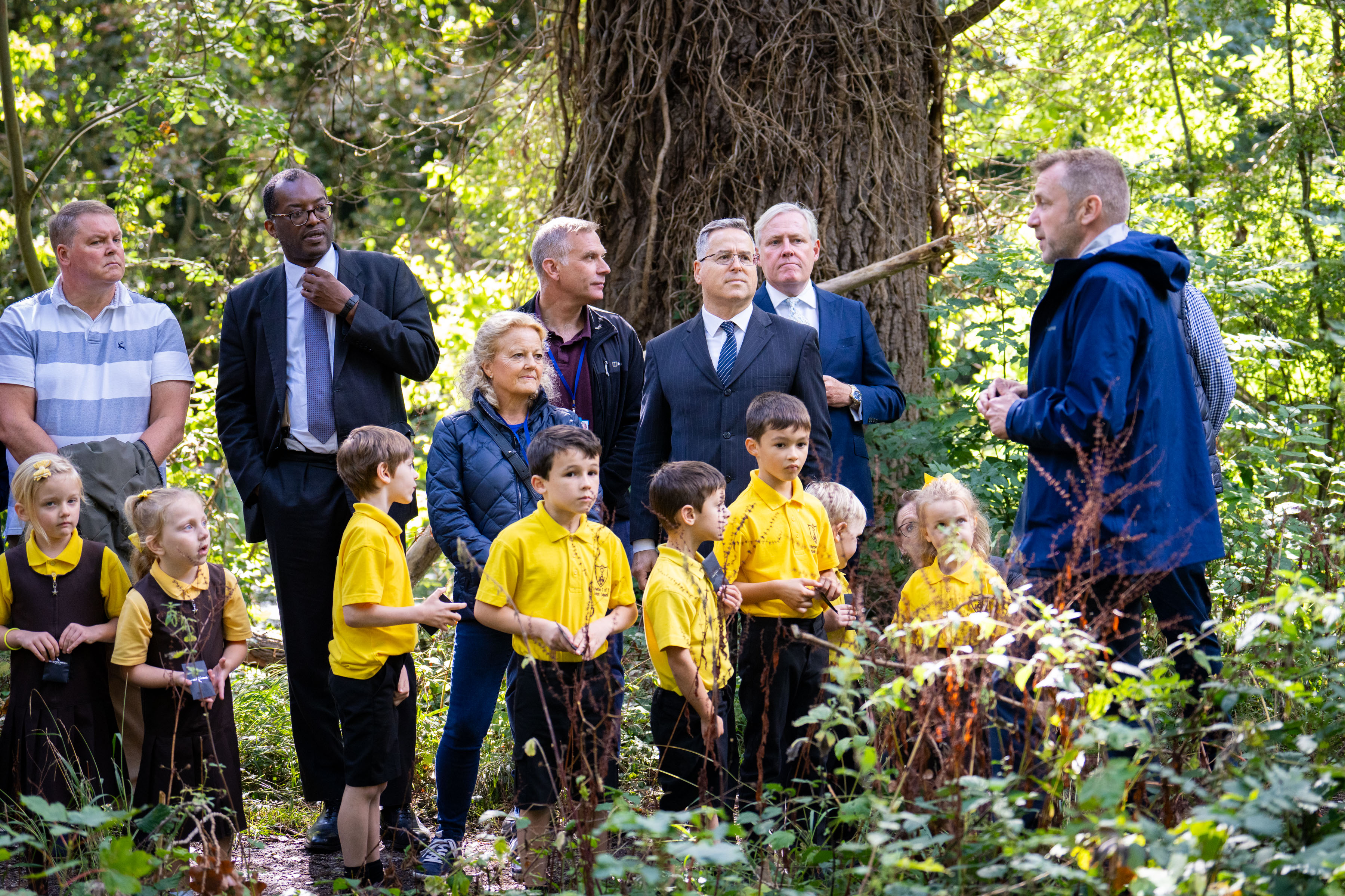 Person to group of people and children in forest