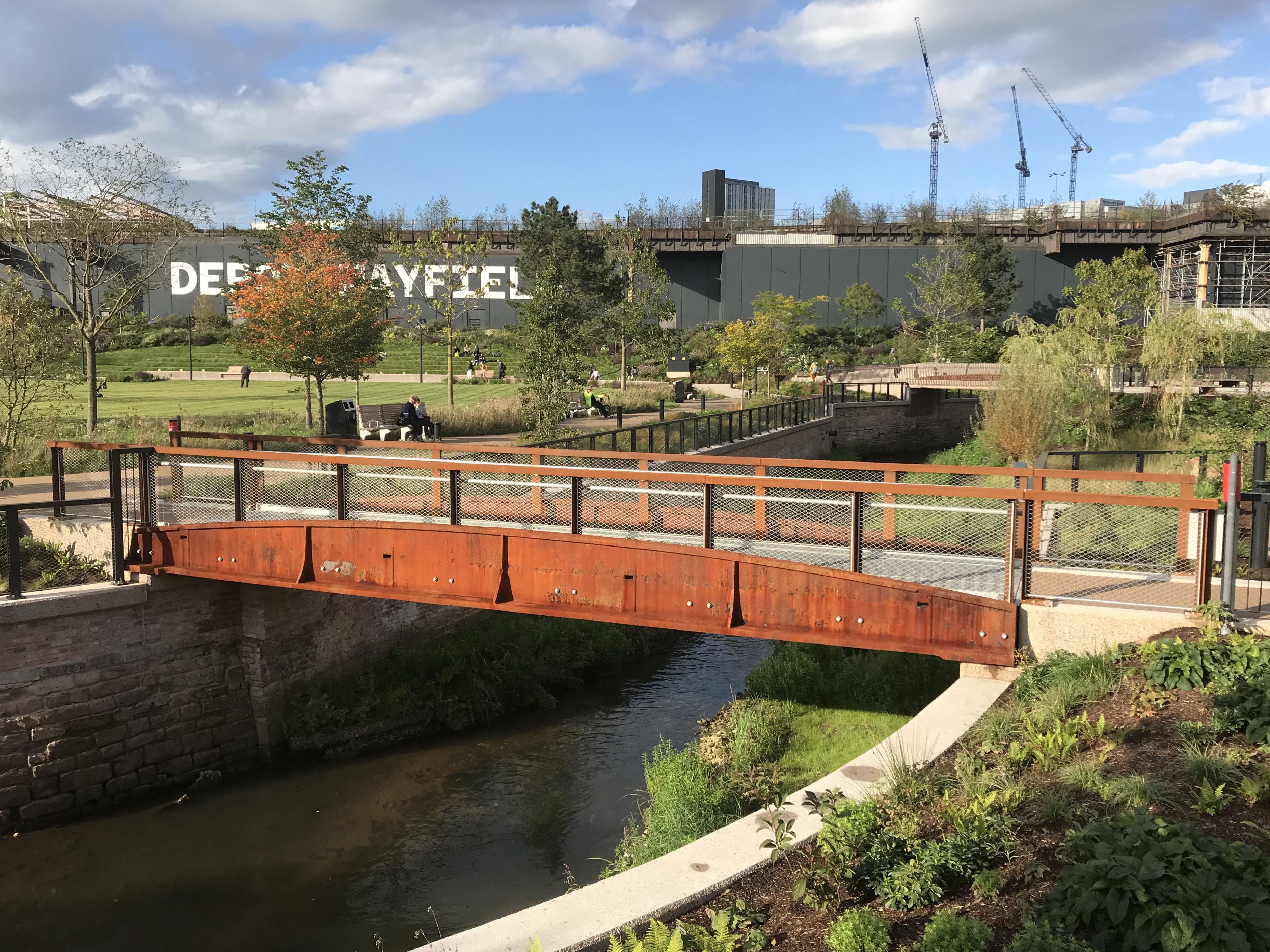 A bridge over water and some park land
