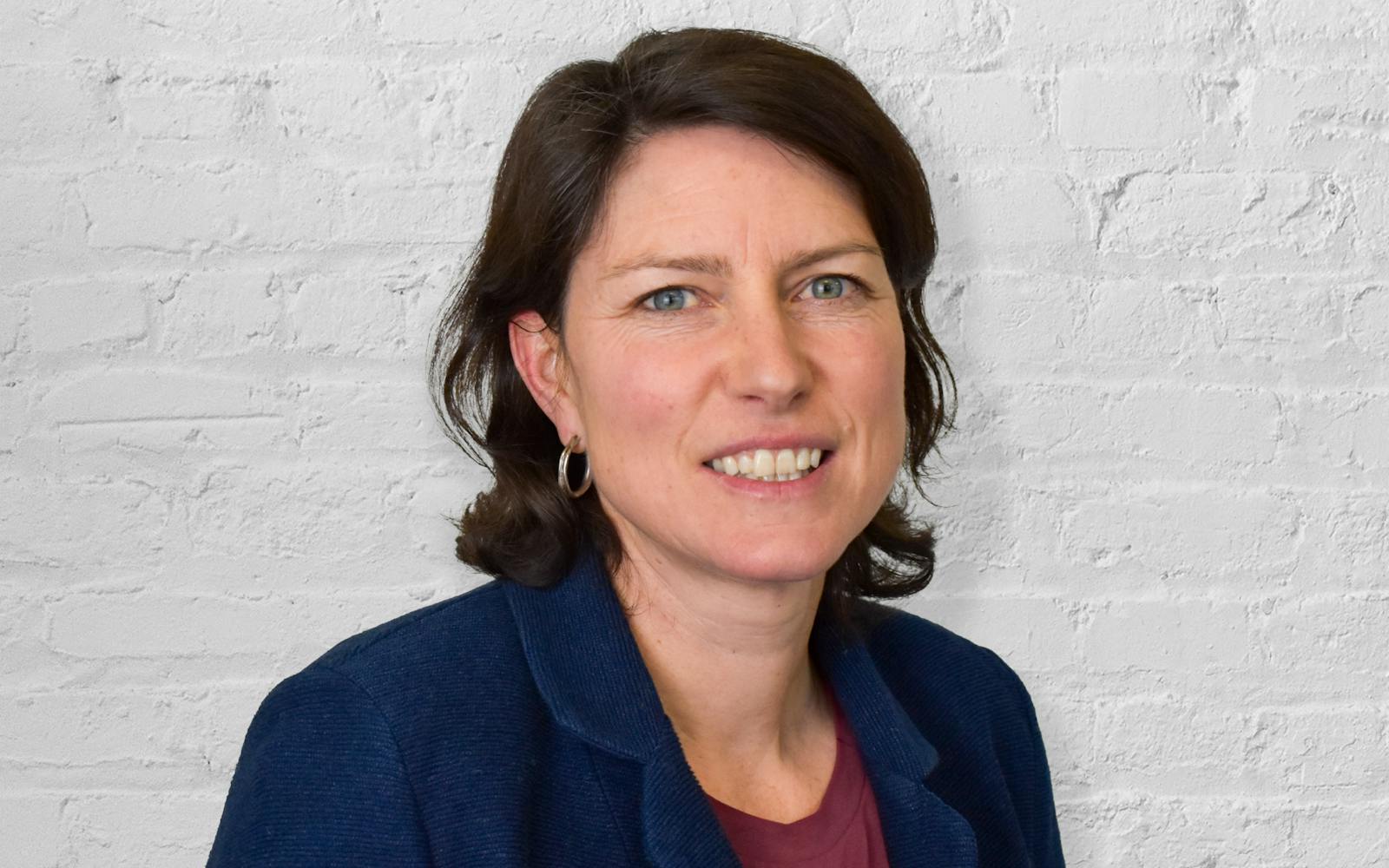 headshot in front of brick wall