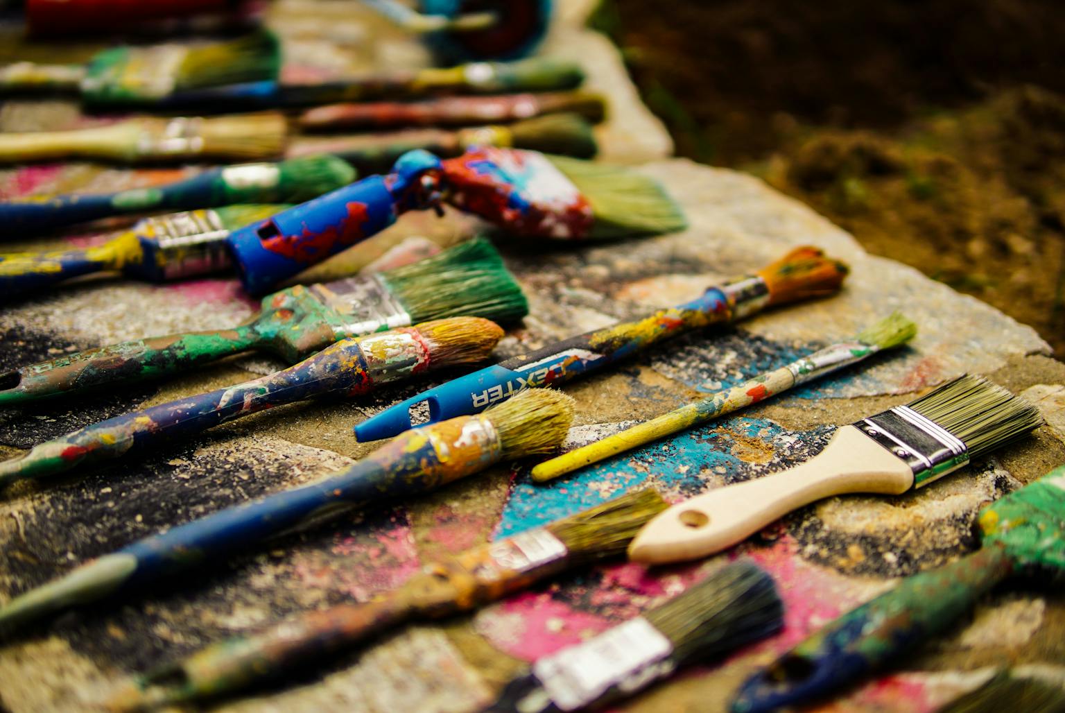 A mound of brushes, different in size and shape, forming a pile.