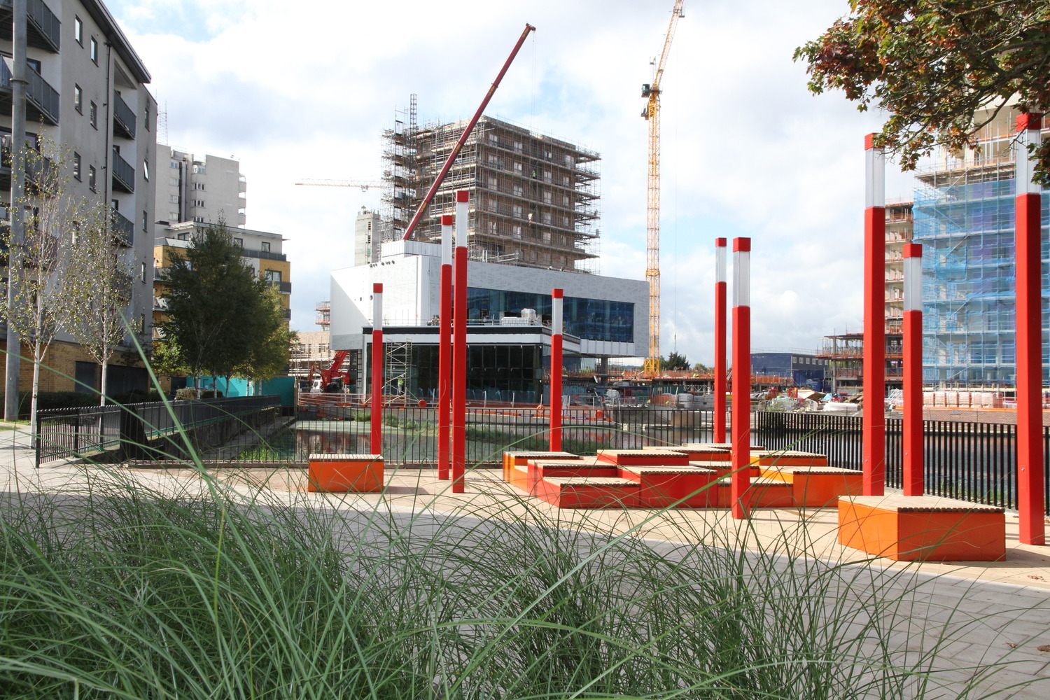 Benches by river and construction site